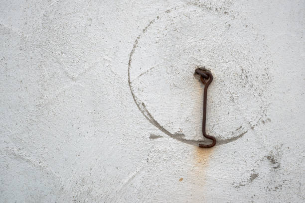 Grinding marks from a metal hook on a white wall
