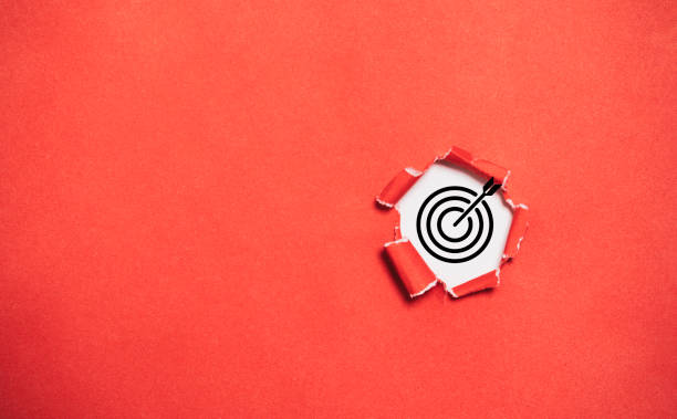 Black target dartboard inside of red drill paper hole with copy space for setup business objective target and goal concept.