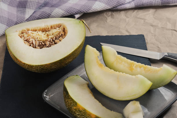 istock yellow melon cut with a knife and melon slices 1351840638
