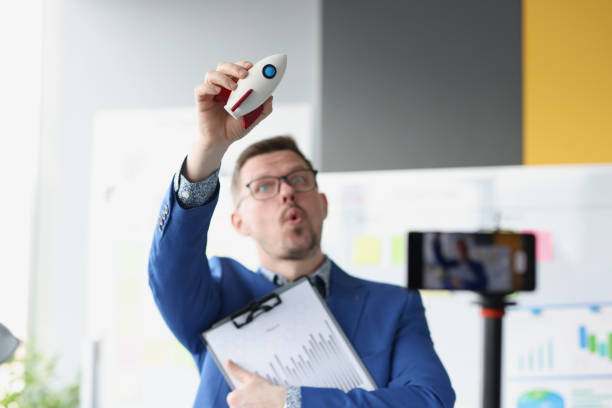 istock Businessman holds rockets and launches up closeup 1351845331