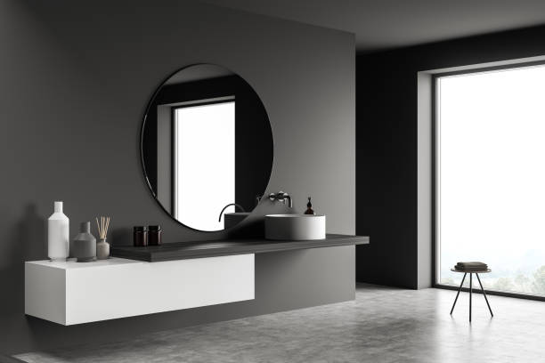 istock Dark bathroom interior with minimalist sink and table with towel near window 1351847762