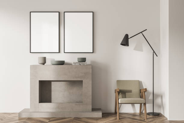 istock Single armchair with two empty canvases on light beige living room wall 1351847934