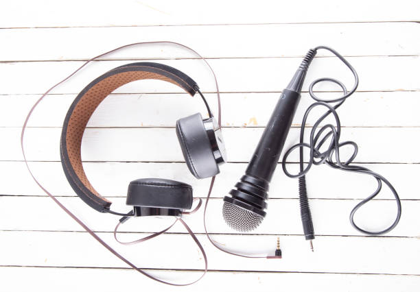 istock Headphones and microphone over white wood 1351849473