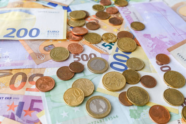 istock Various Euro banknotes an coins as background image for financial topics. 1351849854