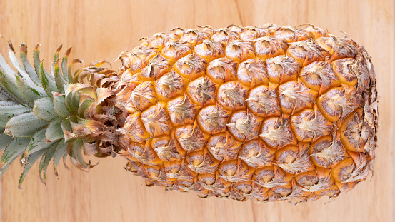 Close-Up Of Ripe pineapple isolated on wooden table