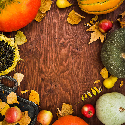Autumn leaves and pumpkin on rustic wooden table