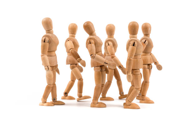 Wooden mannequin walkin in a group