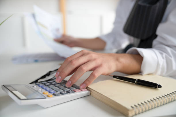 istock Hand of Businessman using calculator calculate expenses monthly bill 1351854199