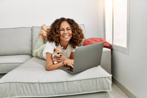 istock Middle age hispanic woman smiling confident using laptop at home 1351854242