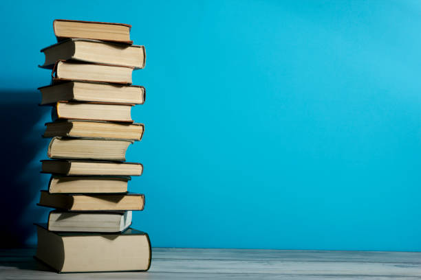 istock Open book, hardback books on wooden table. Back to school. Copy space. 1351856754