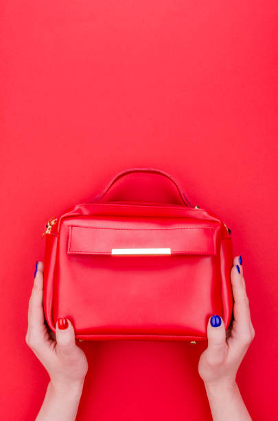 istock Women hands with bright manicure holding bag. 1351856910