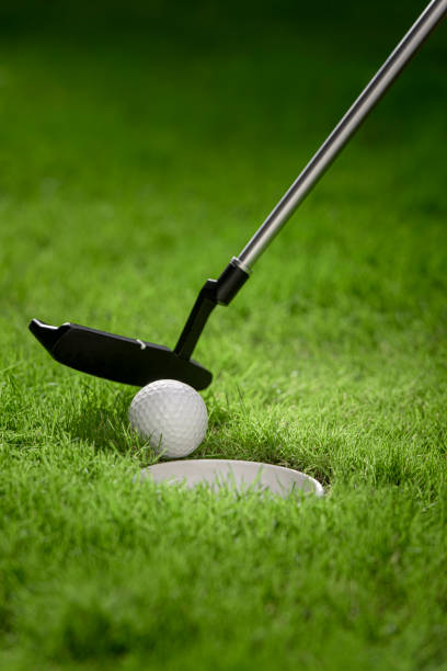 istock A golf club making the final hit in front of the hole. 1351857907