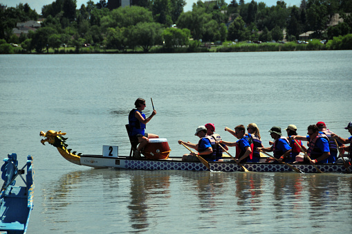 Denver, Colorado, USA: dragon boat racing - dragon boats are open boats with a long, slightly curved keel, they are driven by paddles and designed in such a way that they represent a stylized dragon through painting or carving and a decorative Chinese dragon head and tail - Dragon Boat Festival, Sloan's Lake Park.