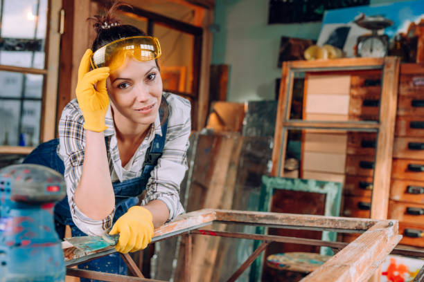 istock Young woman wearing protective glasses working in the workshop 1351858568