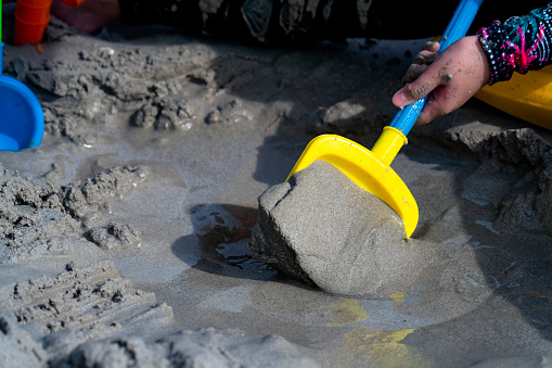 Construction work on the seashore. An excavator dug up a wet sand