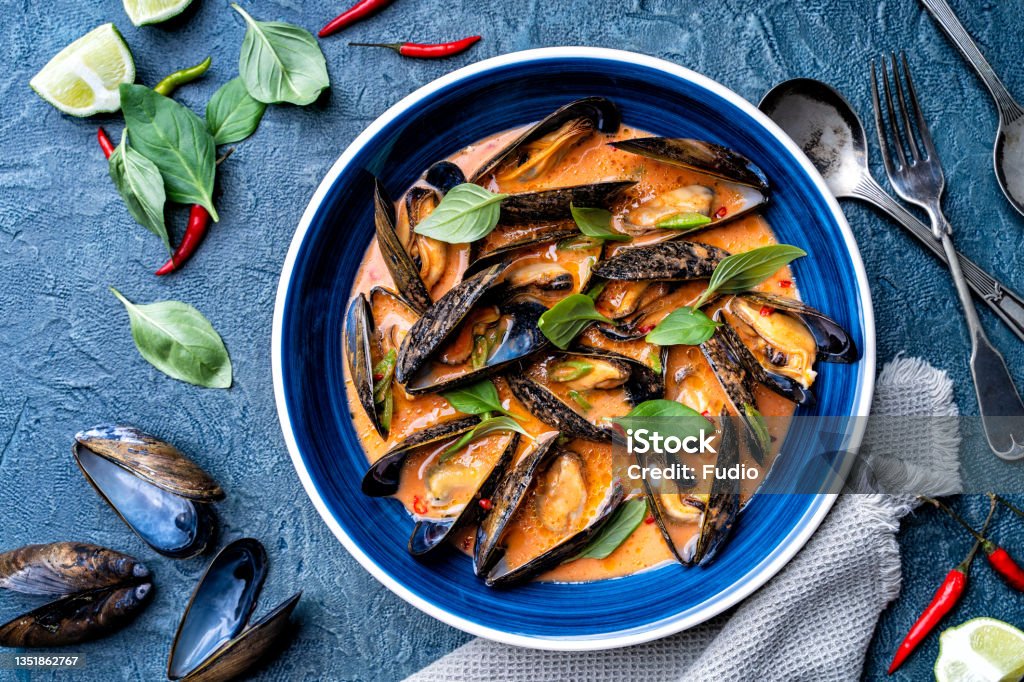 Thai Red Curry Mussels Delicious blue mussels in a spicy thai red curry sauce. Mussel Stock Photo