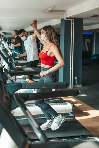 istock Young people wearing face mask in the gym 1351862963
