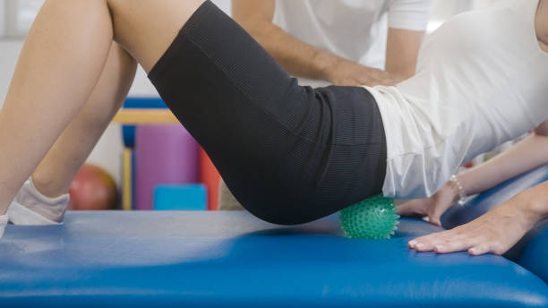 istock Self-massage exercises with a spiky massage ball 1351865290