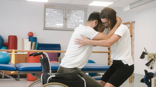 Proper lifting technique from a wheelchair stock photo