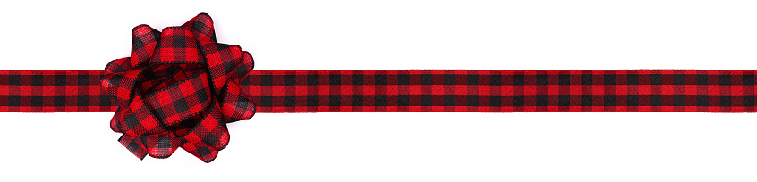 Christmas gift bow and ribbon with red and black buffalo plaid pattern. Long border isolated on a white background.