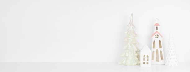 istock White Christmas decor on a shelf against a white wall banner background with copy space 1351867063