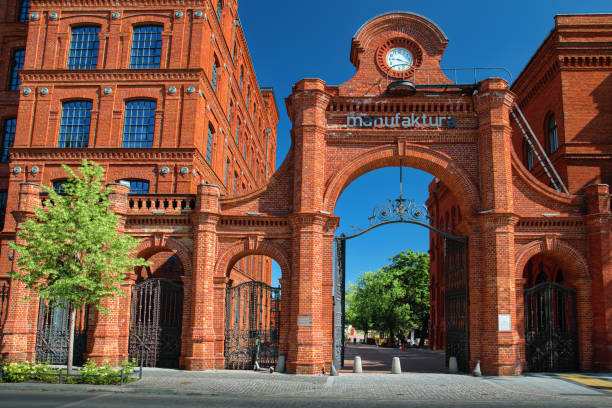 Warsaw, Poland - August 18 2021: Entrance gate to the Manufaktura - an arts centre, shopping mall, and leisure complex in ód, Poland.