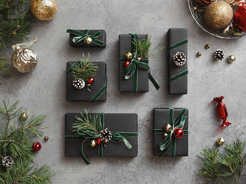 High angle view of Christmas presents wrapped in black paper