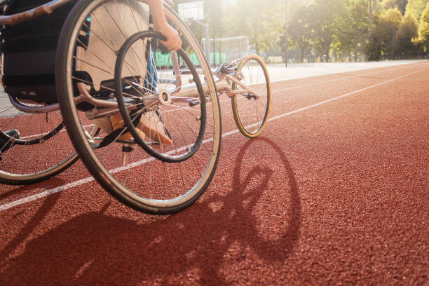 Athletic wheelchair race Athletic stadium track and a race wheelchair on it. adaptive athlete stock pictures, royalty-free photos & images