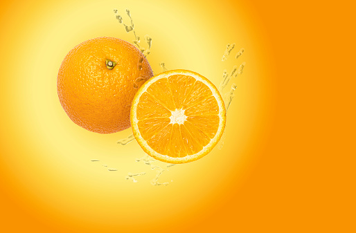 Water drops fresh Orange fruits isolated on Orange background.