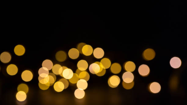 istock Gold sparkling bokeh on  black background for texture or design. Copy space 1351874448