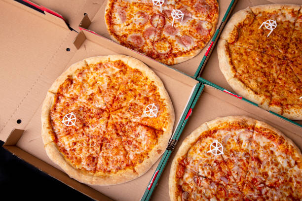 istock Pizzas in a cardboard boxes against a dark background 1351874455