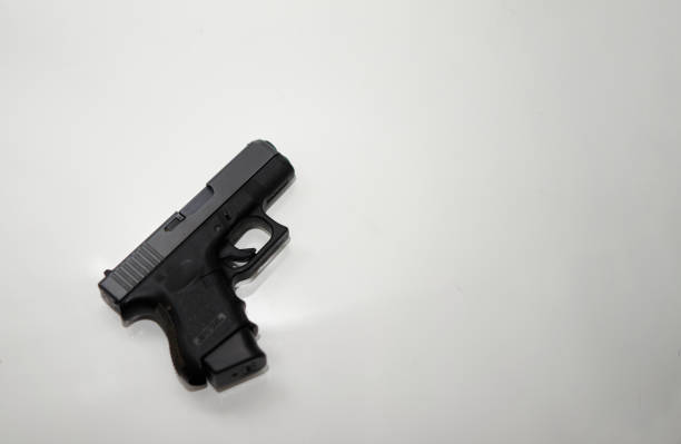 istock pistol magazine hand gun selective focus isolated on white top view and copy space 1351875276