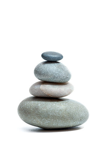 tack of balanced stones at beach against Majestic mountain peaks of the greater Himalayas, en route Manali to Leh, Himachal Pradesh