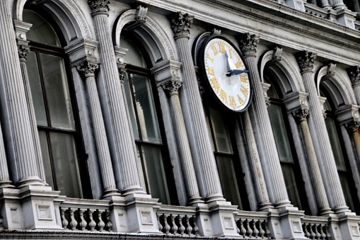 Fifth Avenue Building Clock in New York City. Skyscrapers in the background.