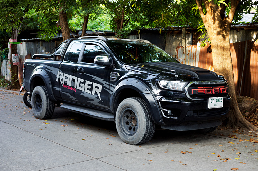 Black Ford Ranger parked in street at fence in Bangkok