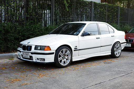 White colored BMW M 325 parked in street of Bangkok