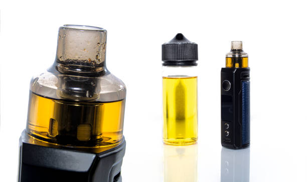 istock Electronic cigarette and vape liquid isolated on white background. 1351880165