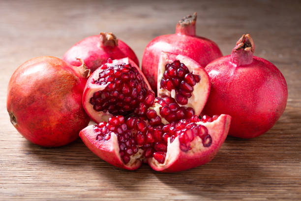 istock fresh pomegranates on a wooden table 1351881793