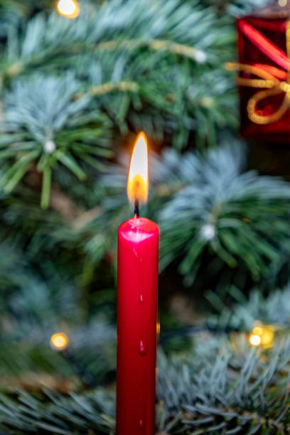 istock burning christmas candles at the xmas tree as old tradition 1351882915