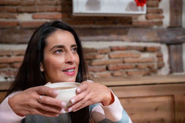istock Thoughtful young woman having a cup of tea. 1351883329