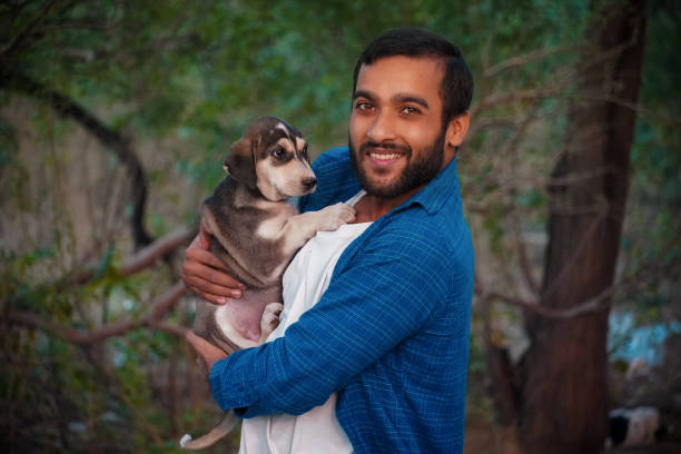 istock man with indian street dog 1351883420