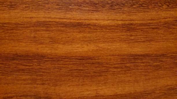 Wood texture, dark brown, orange Closeup wood texture, ideal background image. Dark brown and orange colours. faux wood stock pictures, royalty-free photos & images