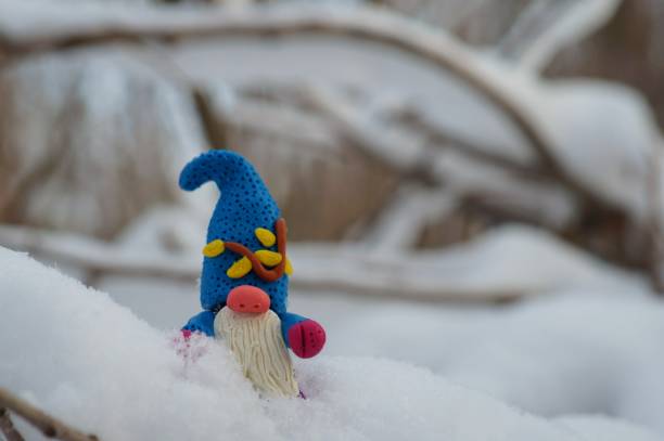 istock Figure of a dwarf in a snowy forest. 1351884759