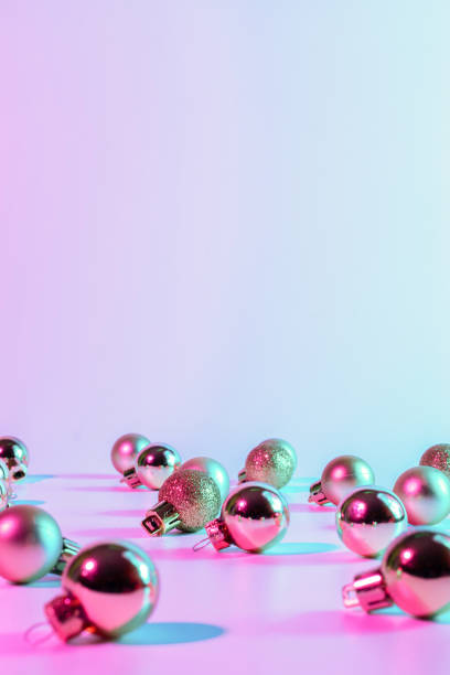 istock Christmas balls pattern neon background. Xmas bauble on abstract holiday winter gradient backdrop. Happy new year copy space. 1351885845