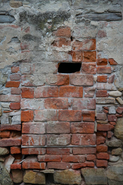 istock An old colored wall of broken stones. There's a space between the wall. The image is suitable for the background 1351886895