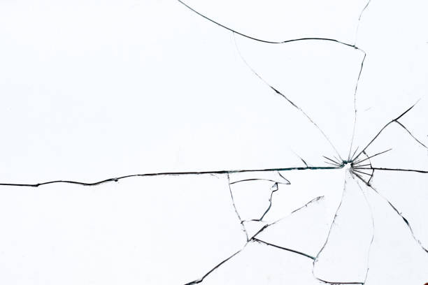 bullet hole in broken glass on a white background. shards of glass - 玻璃 個照片及圖片檔