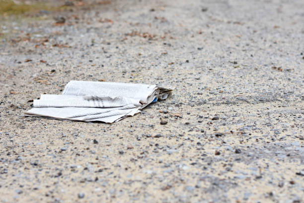 istock The discarded crumpled book lies on the ground. Unnecessary book 1351888389