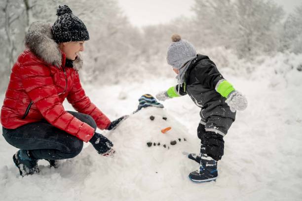 istock Mother and a son spending winter day outside on the snow 1351889251