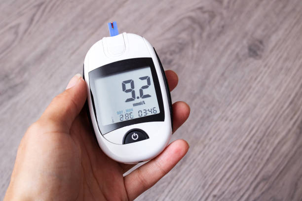 istock Female hands and glucometer measuring blood sugar 1351889369