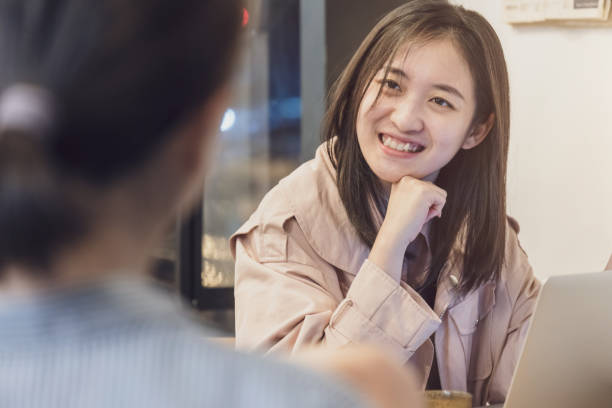 istock Young Woman Greets customer in coffee Shop 1351889390